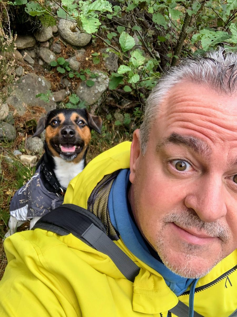 Neil and his Jack Russell Max smiling together on a walk
